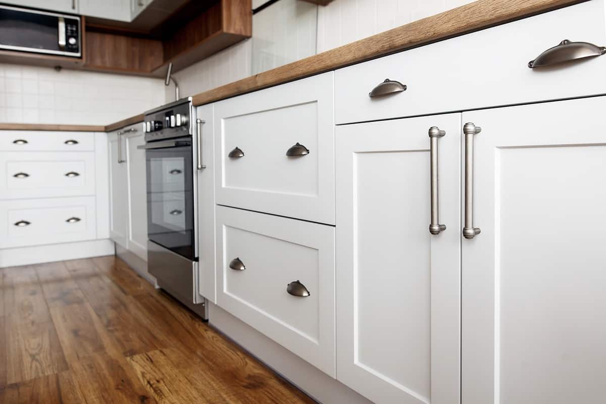 White kitchen cabinets with silver handles