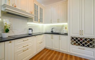 All white kitchen cabinets with glossy black counter - cabinet painting