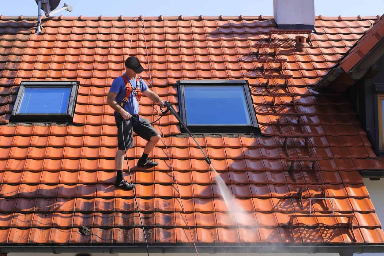 Pressure Washing Worker power washing residential roof